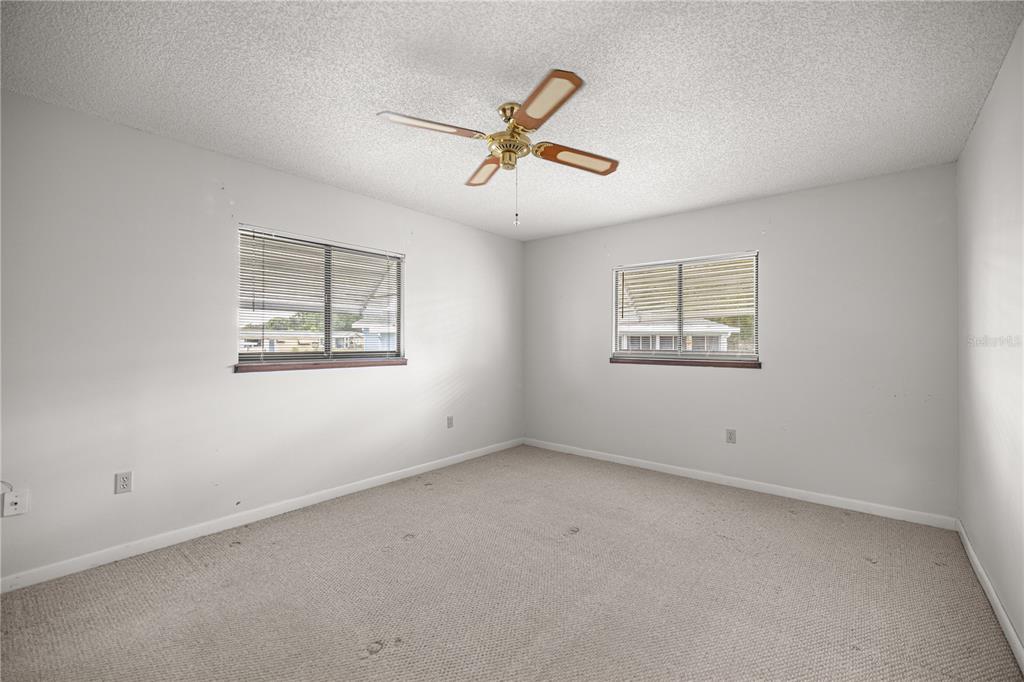 9230 Southwest 101st Lane Ocala, FL 34481 - Photo 16 of 31 an empty room with a window and a ceiling fan