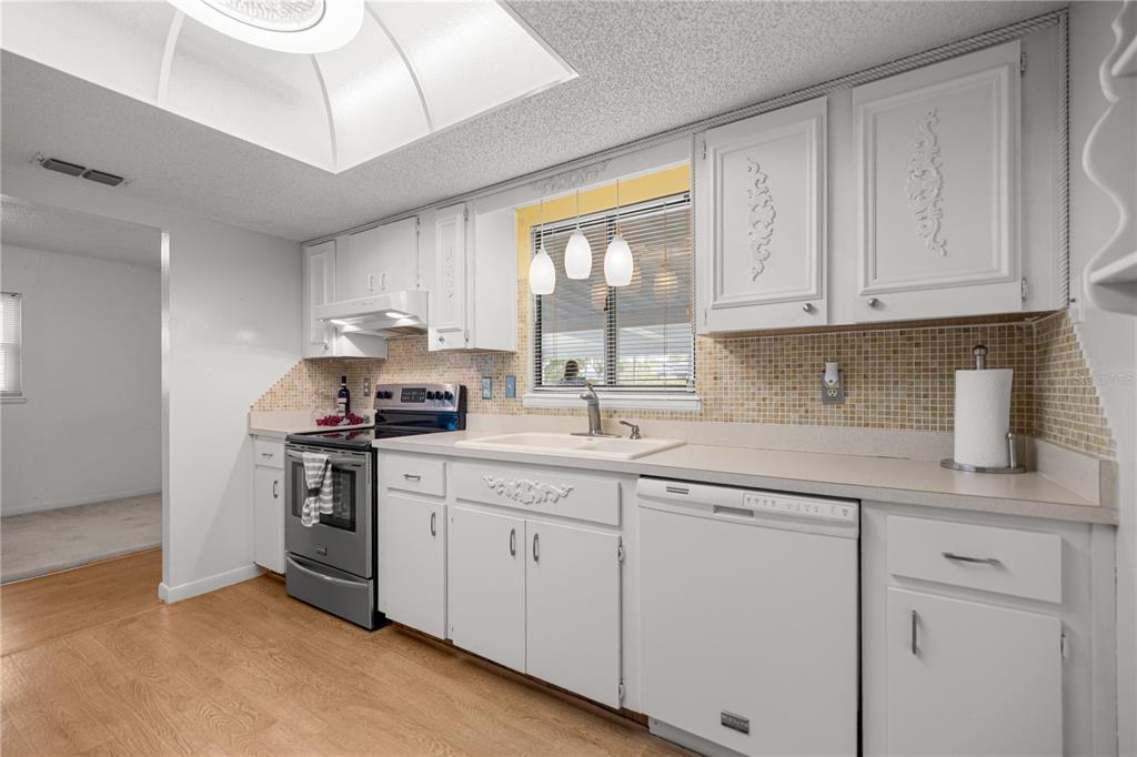 9230 Southwest 101st Lane Ocala, FL 34481 - Photo 7 of 31 a kitchen with granite countertop white cabinets and white appliances