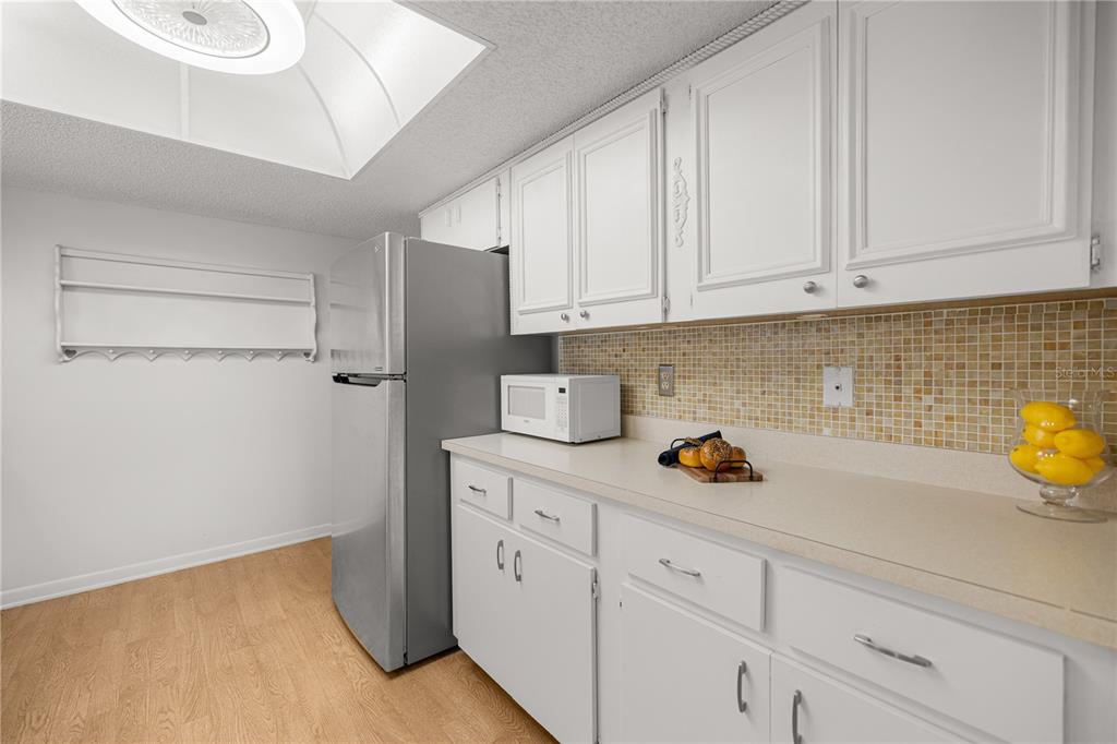 9230 Southwest 101st Lane Ocala, FL 34481 - Photo 8 of 31 a kitchen with white cabinets and a sink