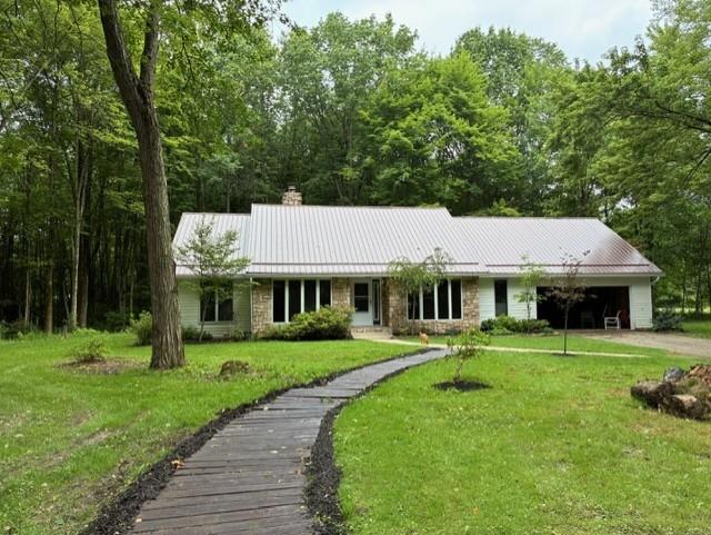 a front view of a house with a yard and trees