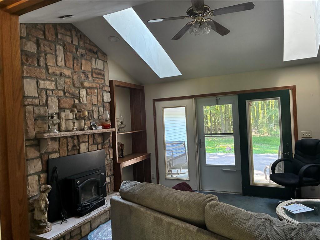 5569 East State Street Hermitage, PA 16148 - Photo 4 of 11 a living room with furniture a fireplace and a floor to ceiling window