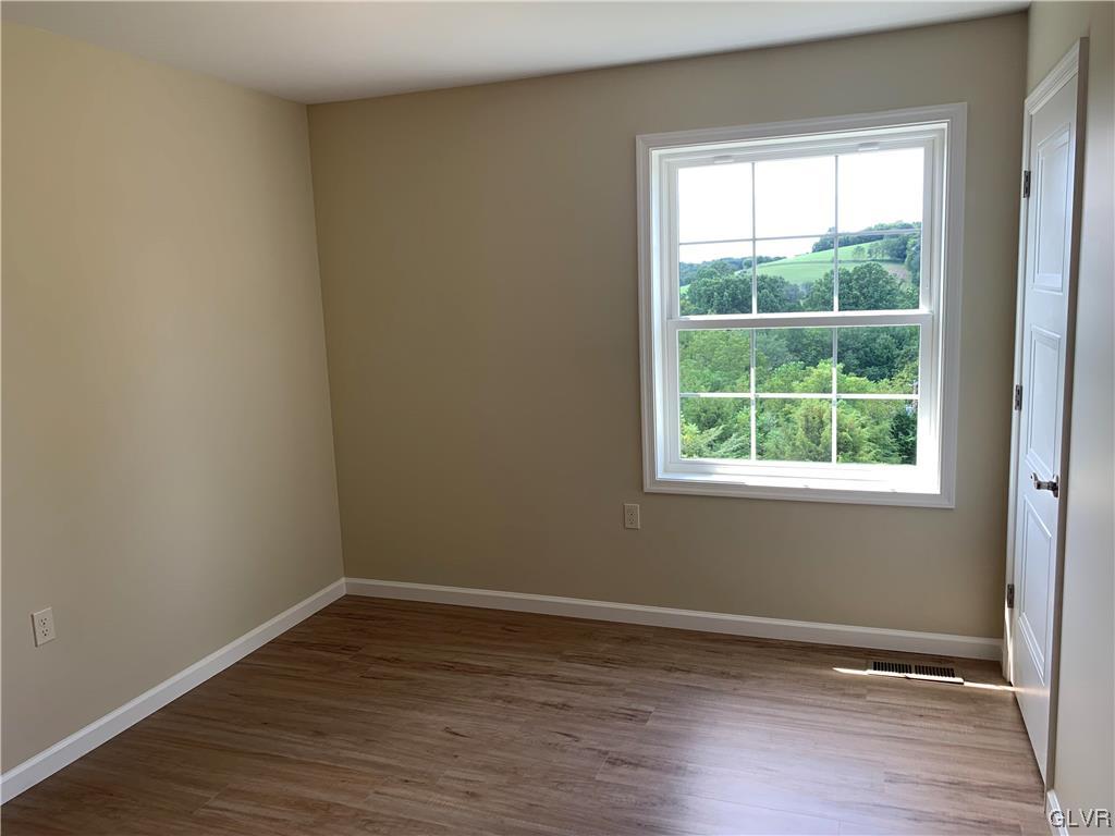 276 Hester Road Bangor, PA 18013 - Photo 22 of 26 a view of an empty room with wooden floor and a window