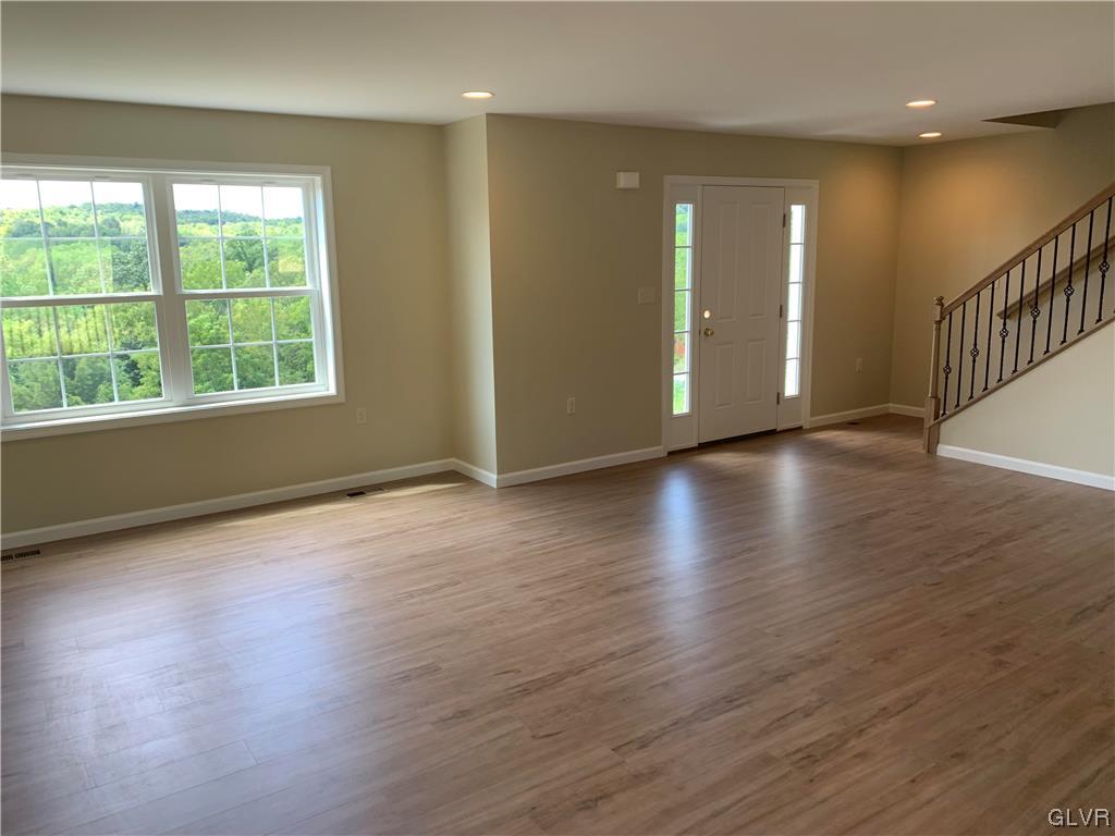 276 Hester Road Bangor, PA 18013 - Photo 4 of 26 an empty room with wooden floor and windows