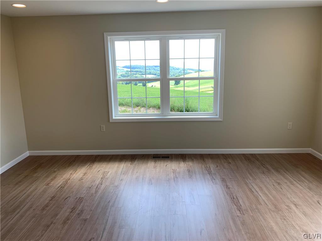 276 Hester Road Bangor, PA 18013 - Photo 7 of 26 an empty room with wooden floor and windows
