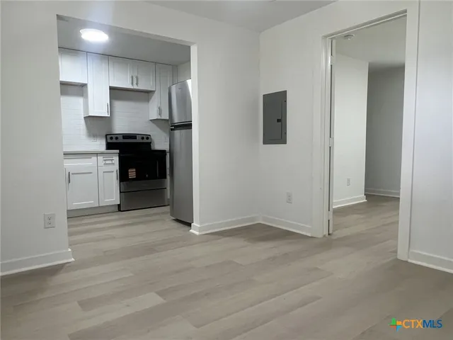 a view of kitchen with wooden floor