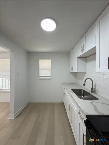 a kitchen with a sink and cabinets