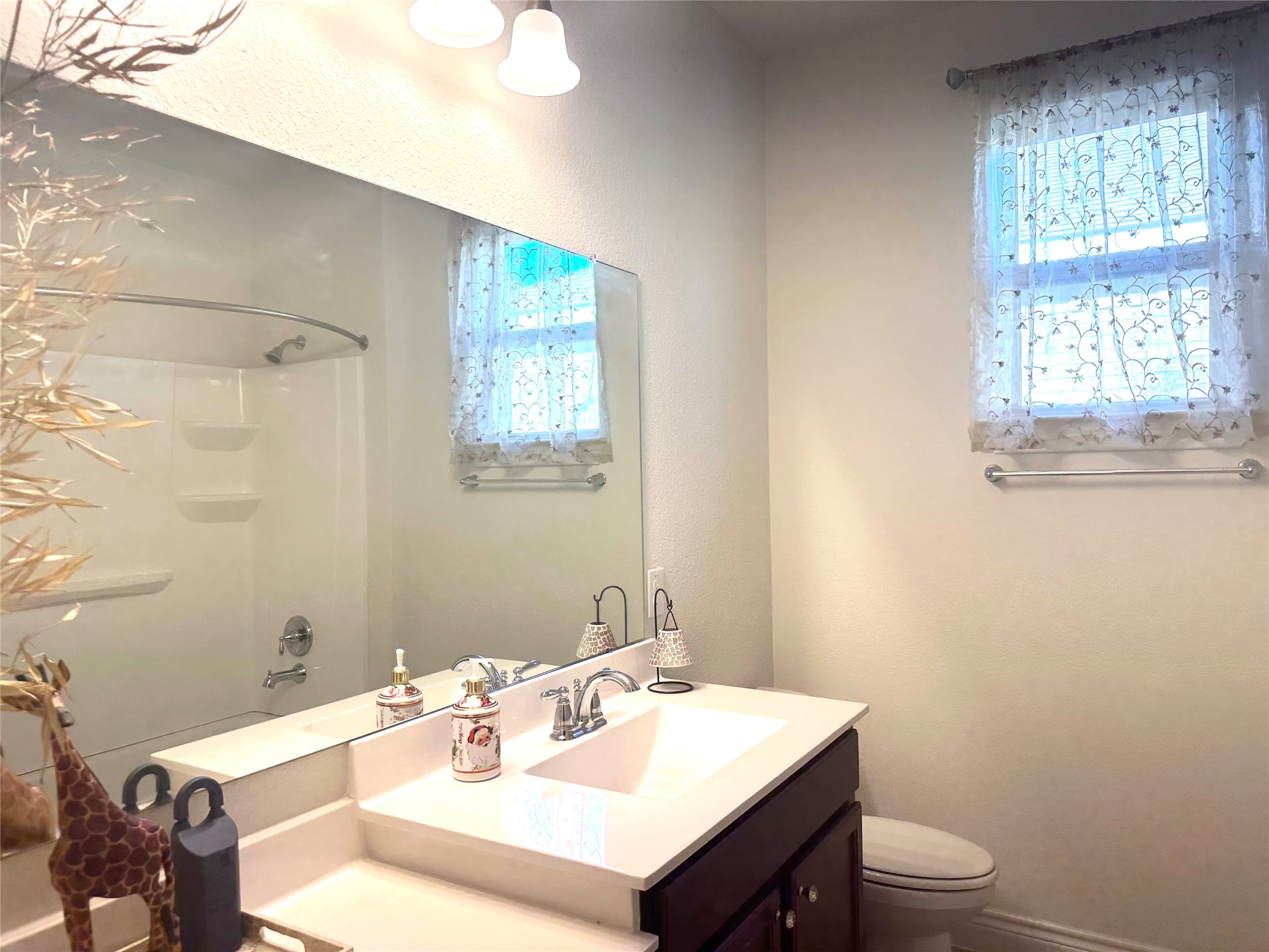 9719 Hazel Fern Court Spring, TX 77379 - Photo 11 of 21 a bathroom with a sink vanity mirror and toilet