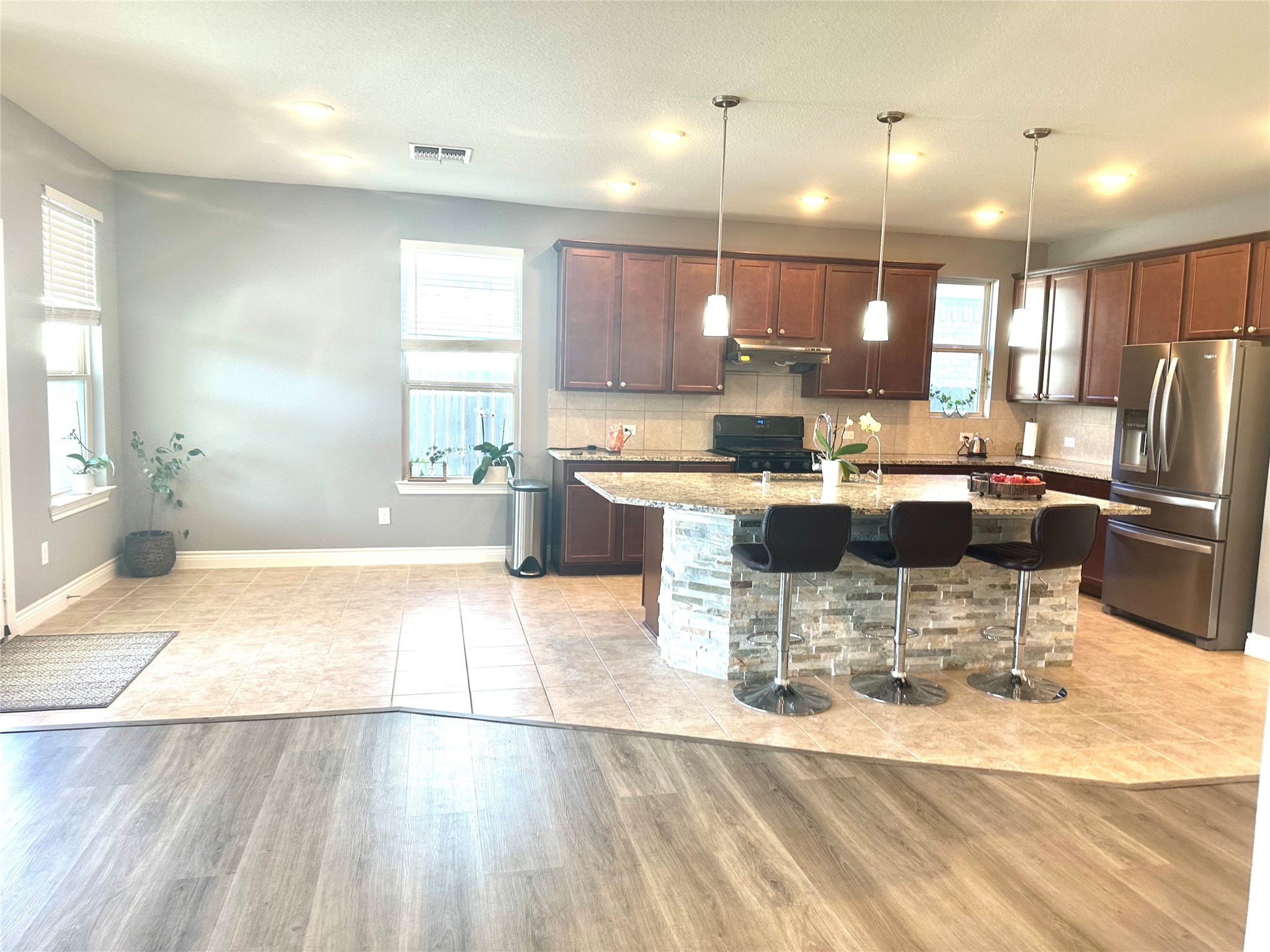 9719 Hazel Fern Court Spring, TX 77379 - Photo 4 of 21 a kitchen with a dining table chairs and refrigerator