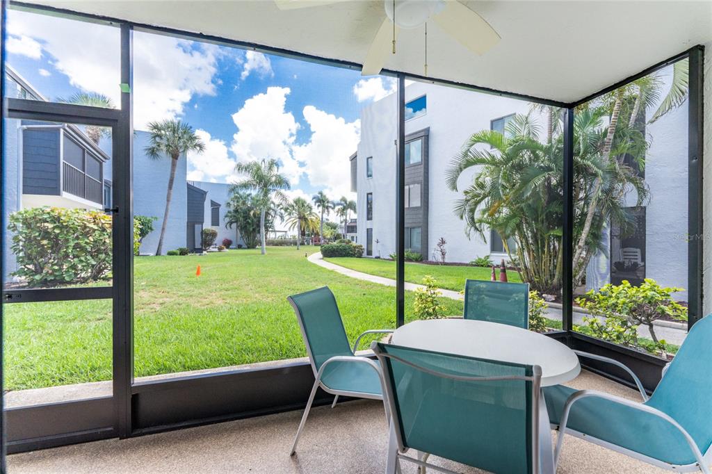 2955 North Beach Road, Unit B614 Englewood, FL 34223 - Photo 11 of 67 a view of a porch with chairs and a table