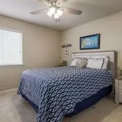 a bedroom with a bed and a painting on the wall