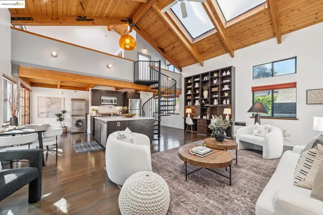 a living room with furniture a rug and a table