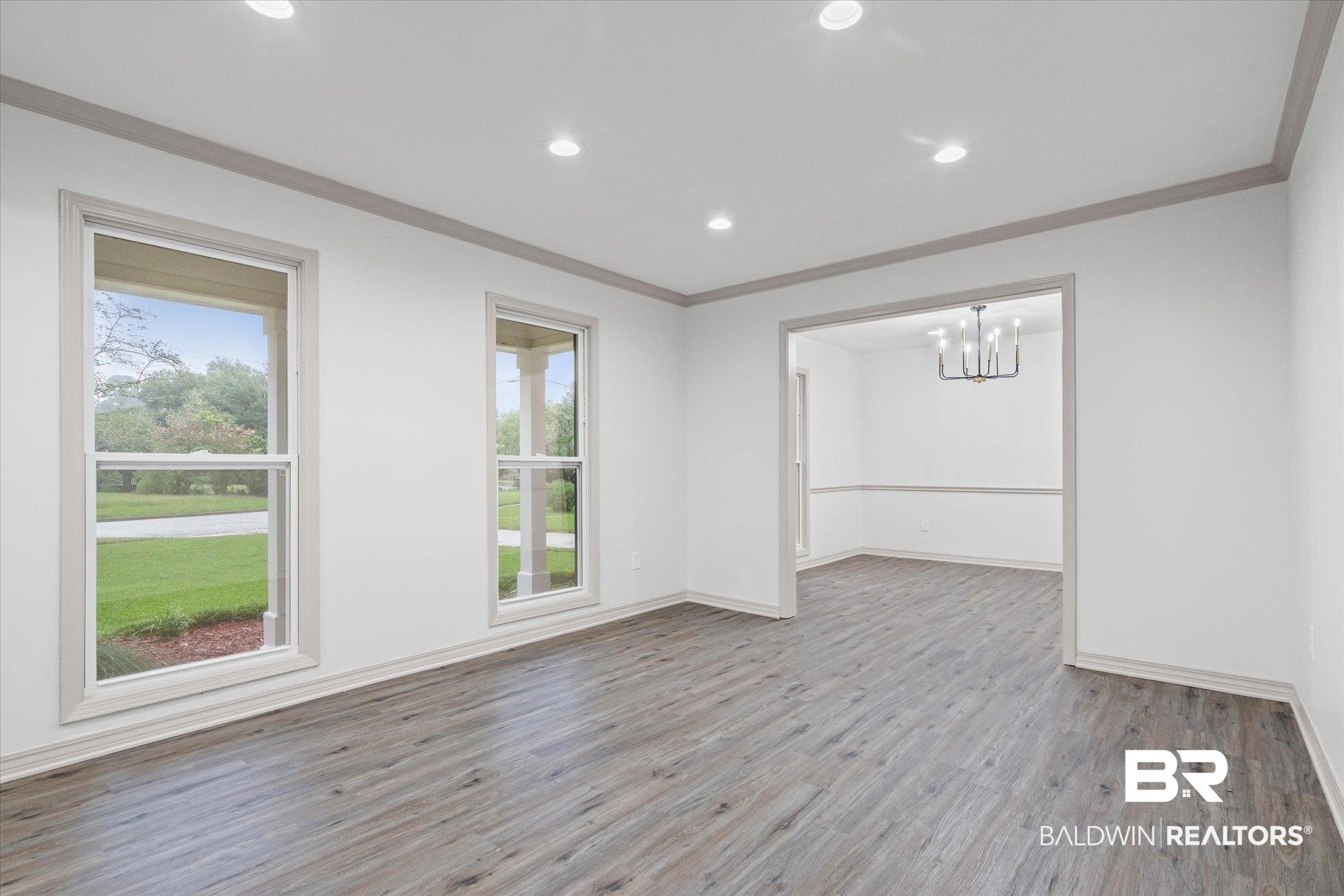 3655 Claridge Road South Mobile, AL 36608 - Photo 5 of 32 Spare room featuring ornamental molding, light wood-style floors, recessed lighting, and a chandelier