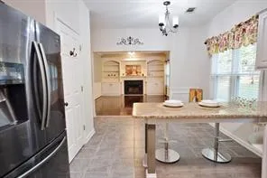 a kitchen with stainless steel appliances granite countertop a sink refrigerator and microwave