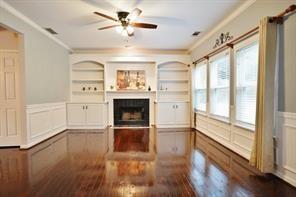 2525 Falcon Chase Court Suwanee, GA 30024 - Photo 3 of 27 a view of a livingroom with a fireplace a ceiling fan and windows