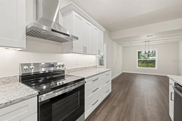 a kitchen with a stove top oven and cabinets