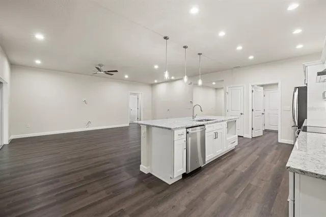 a large white kitchen with a white stove top oven and refrigerator