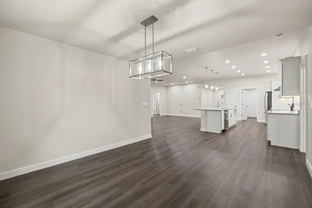 a view of a kitchen with wooden floor and windows