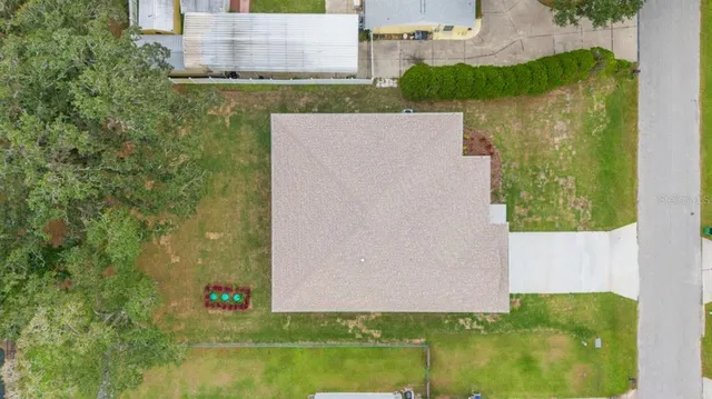 an aerial view of a house with a yard