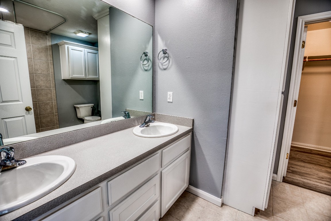 2700 Quarry Road Brenham, TX 77833 - Photo 12 of 35 a bathroom with a granite countertop sink and a mirror
