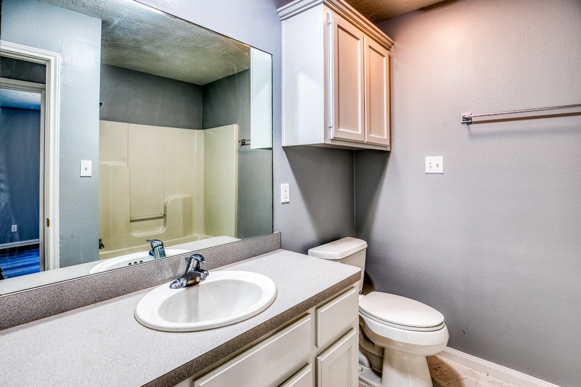 2700 Quarry Road Brenham, TX 77833 - Photo 15 of 35 a bathroom with a sink toilet and mirror