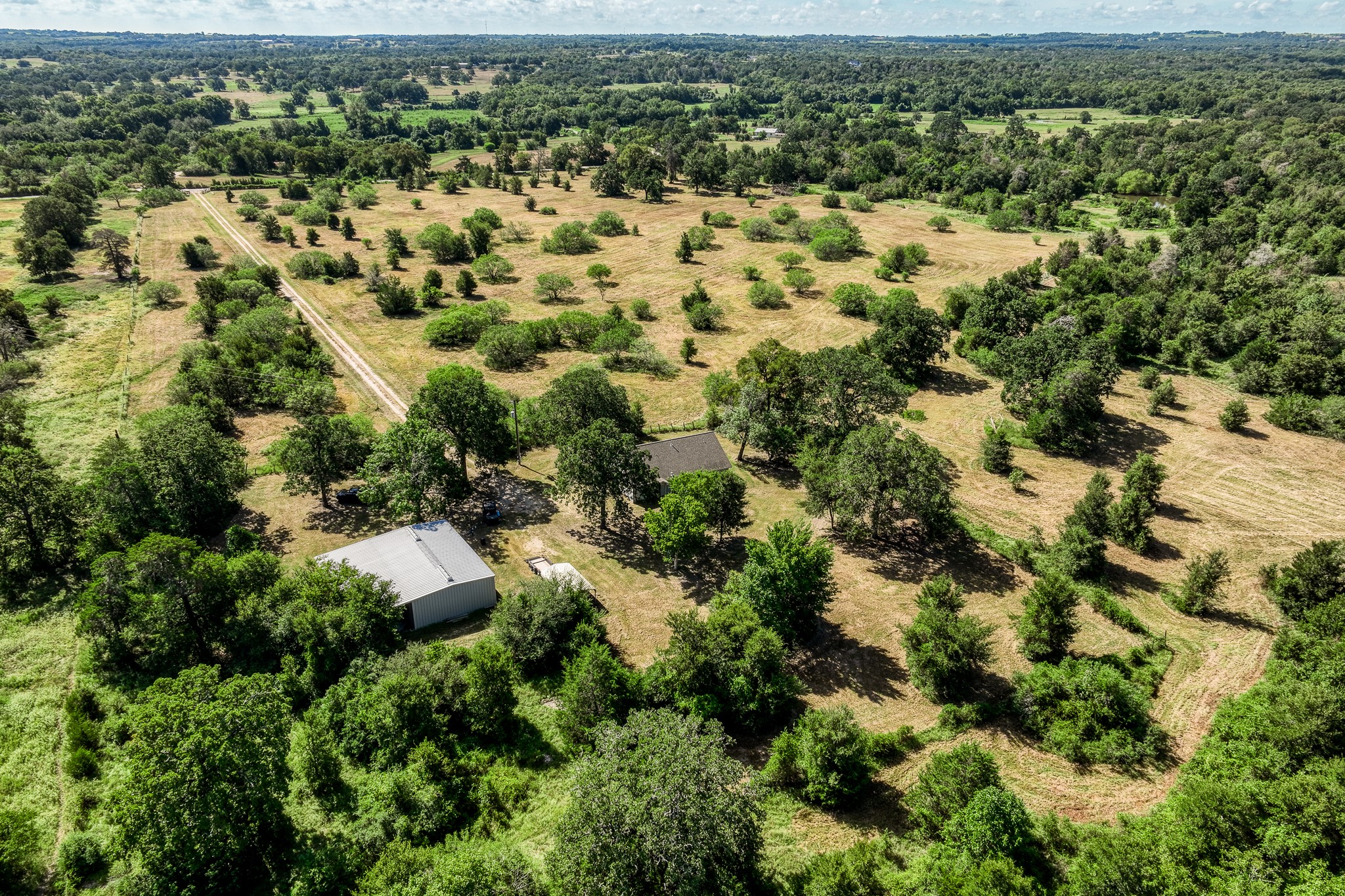 2700 Quarry Road Brenham, TX 77833 - Photo 19 of 35 an aerial view of residential houses with outdoor space and trees