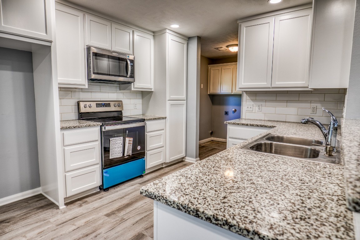 2700 Quarry Road Brenham, TX 77833 - Photo 10 of 35 a kitchen with stainless steel appliances granite countertop a stove a sink and a microwave