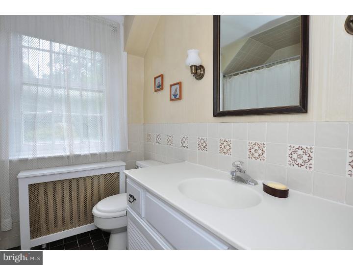 125 Spencer Road Devon, PA 19333 - Photo 22 of 25 a bathroom with a sink a toilet and a mirror