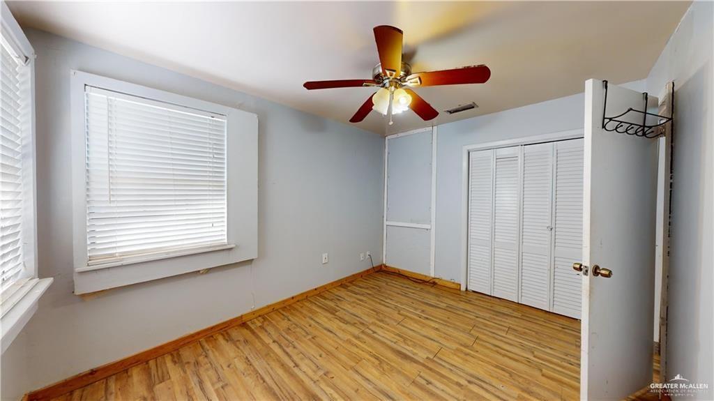 402 South Main Street Donna, TX 78537 - Photo 8 of 17 a view of empty room with wooden floor and fan