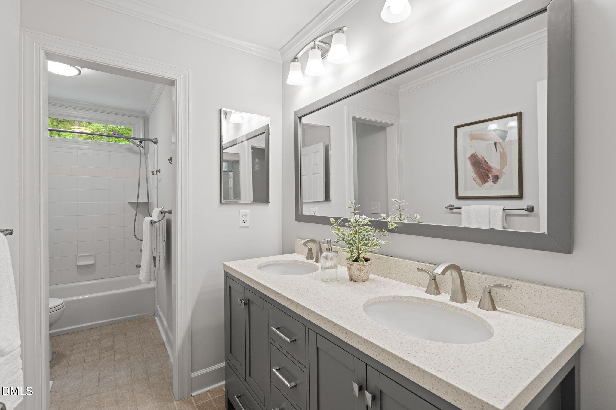 5809 Stone Spring Road Raleigh, NC 27613 - Photo 32 of 54 a bathroom with a sink double vanity and a mirror