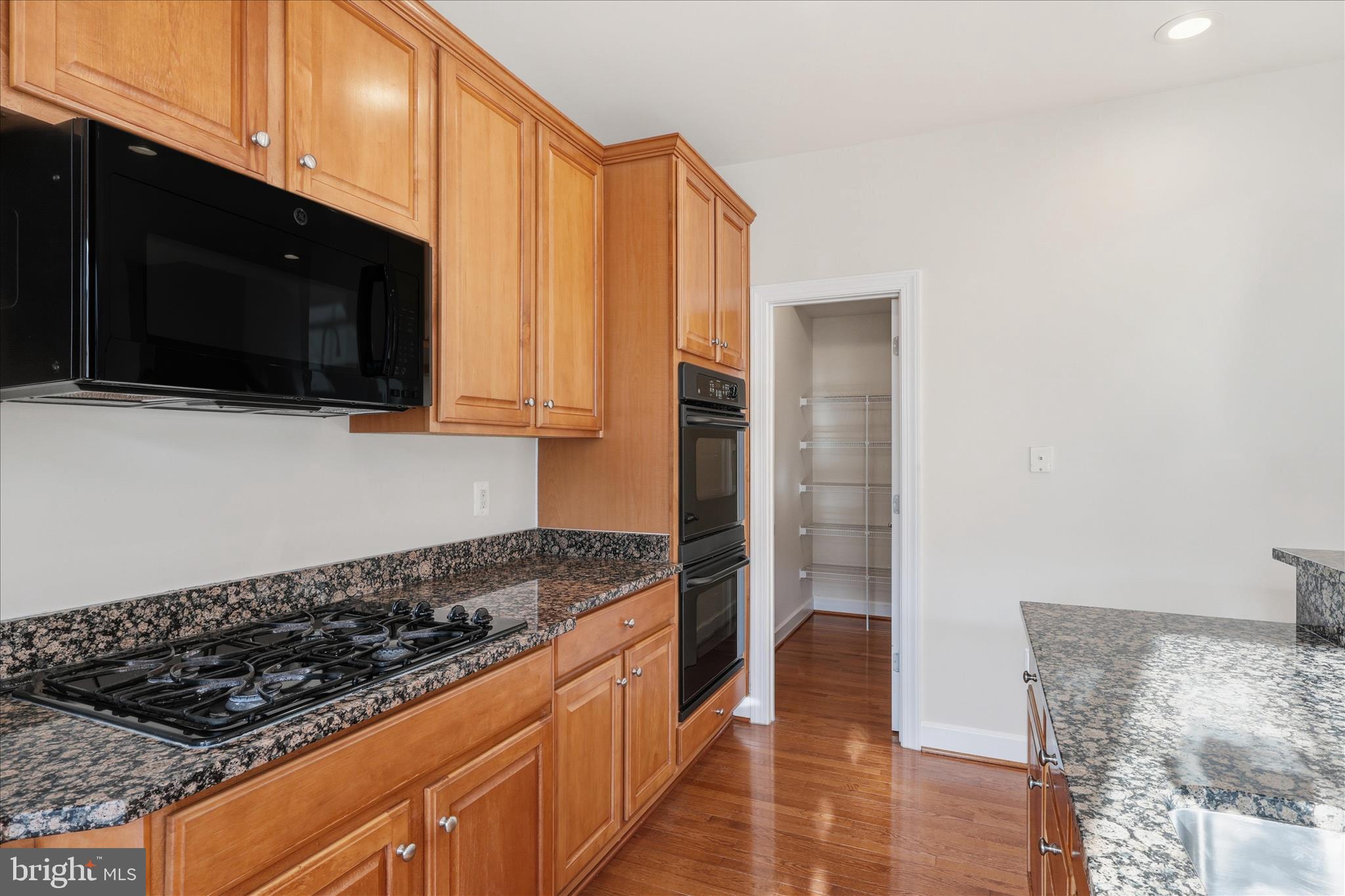 411 Spring Street Herndon, VA 20170 - Photo 19 of 46 a kitchen with stainless steel appliances a stove a microwave and cabinets