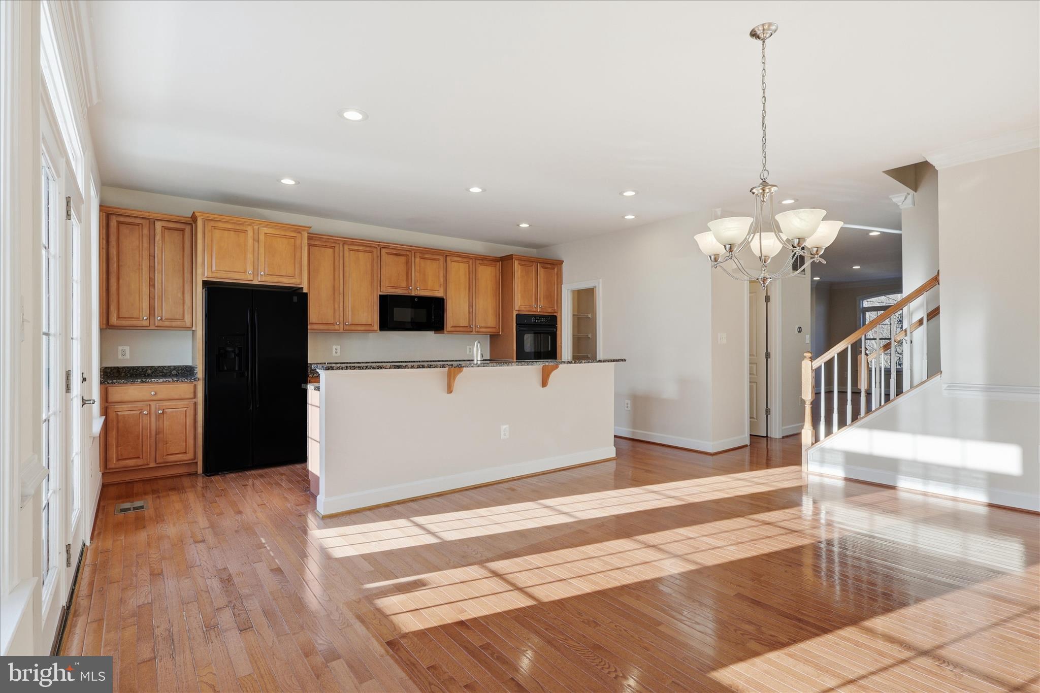 411 Spring Street Herndon, VA 20170 - Photo 22 of 46 a view of a kitchen with a sink refrigerator and wooden floor