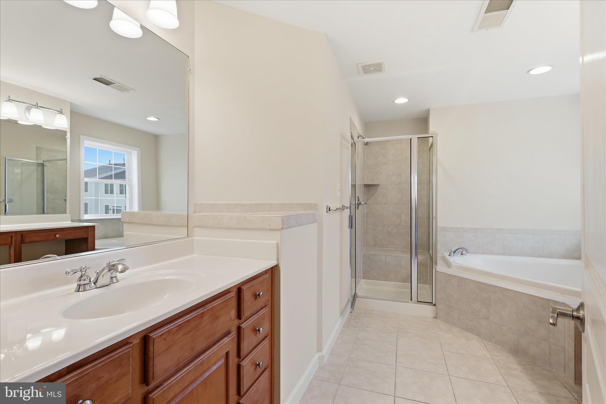 411 Spring Street Herndon, VA 20170 - Photo 29 of 46 a bathroom with a sink double vanity granite tub shower and a mirror