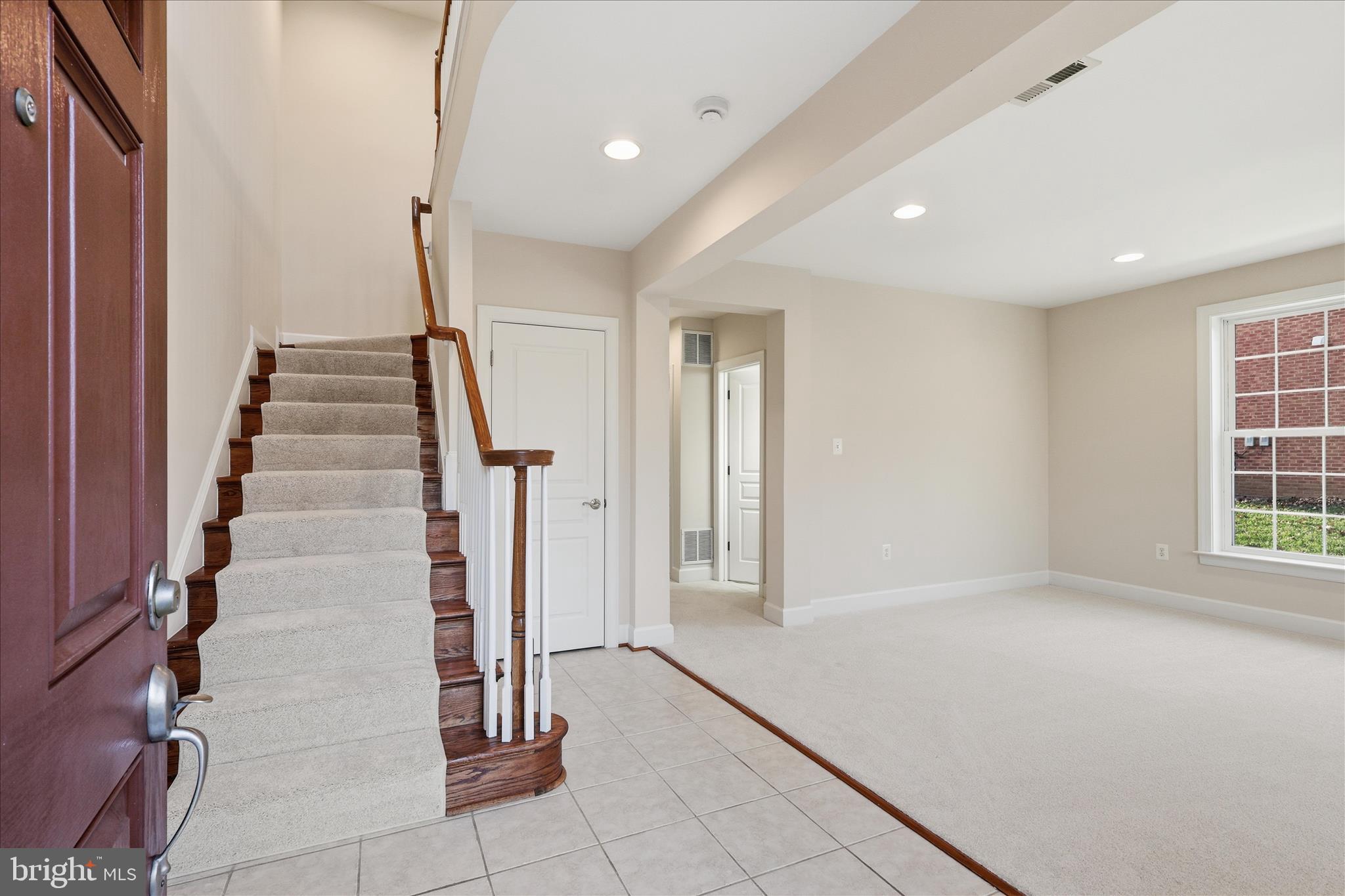 411 Spring Street Herndon, VA 20170 - Photo 5 of 46 a view of entryway with wooden floor and stairs