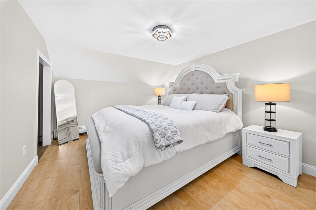 24 Miller Road Wilmington, MA 01887 - Photo 27 of 40 a bedroom with a bed and a lamp on table