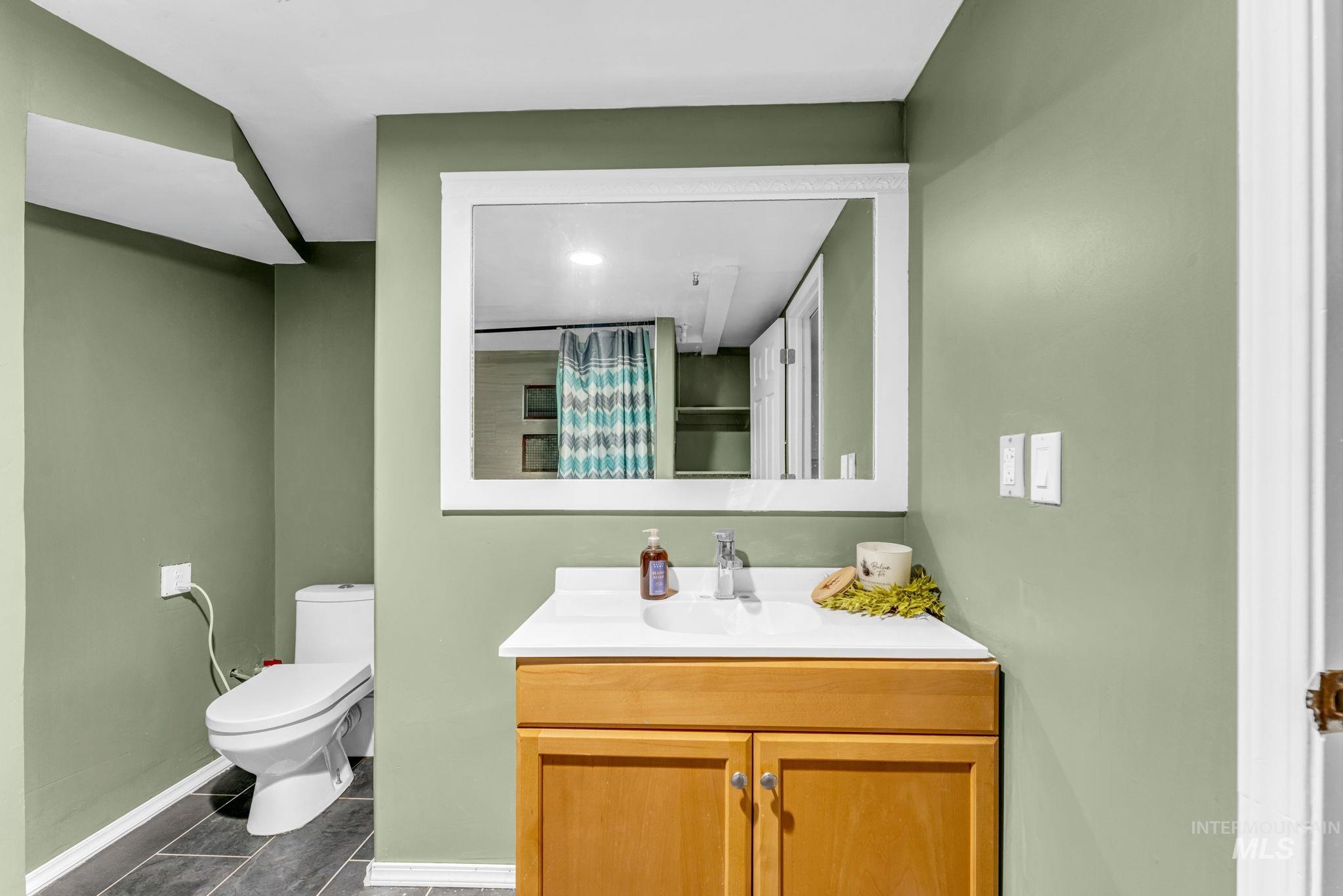 820 Meadows Drive Twin Falls, ID 83301 - Photo 24 of 38 Spacious room featuring textured white walls, a brown carpeted floor, and a flush-mount ceiling light