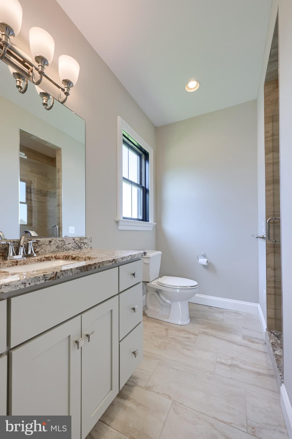 428 Southampton Drive Lititz, PA 17543 - Photo 46 of 60 a bathroom with a granite countertop sink a toilet and a mirror