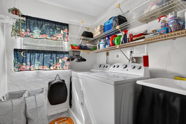 an aerial view of residential houses with outdoor space and parking