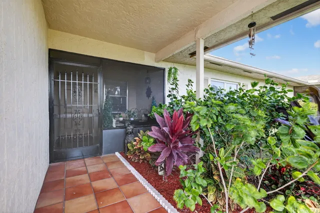 an aerial view of residential houses with outdoor space and swimming pool