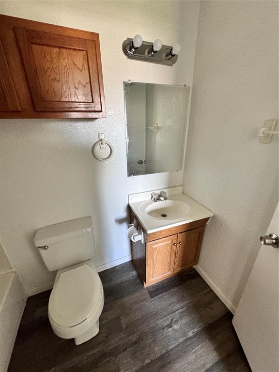 1808 Spring Lake West Brownwood, TX 76801 - Photo 6 of 12 a bathroom with a toilet a sink and mirror