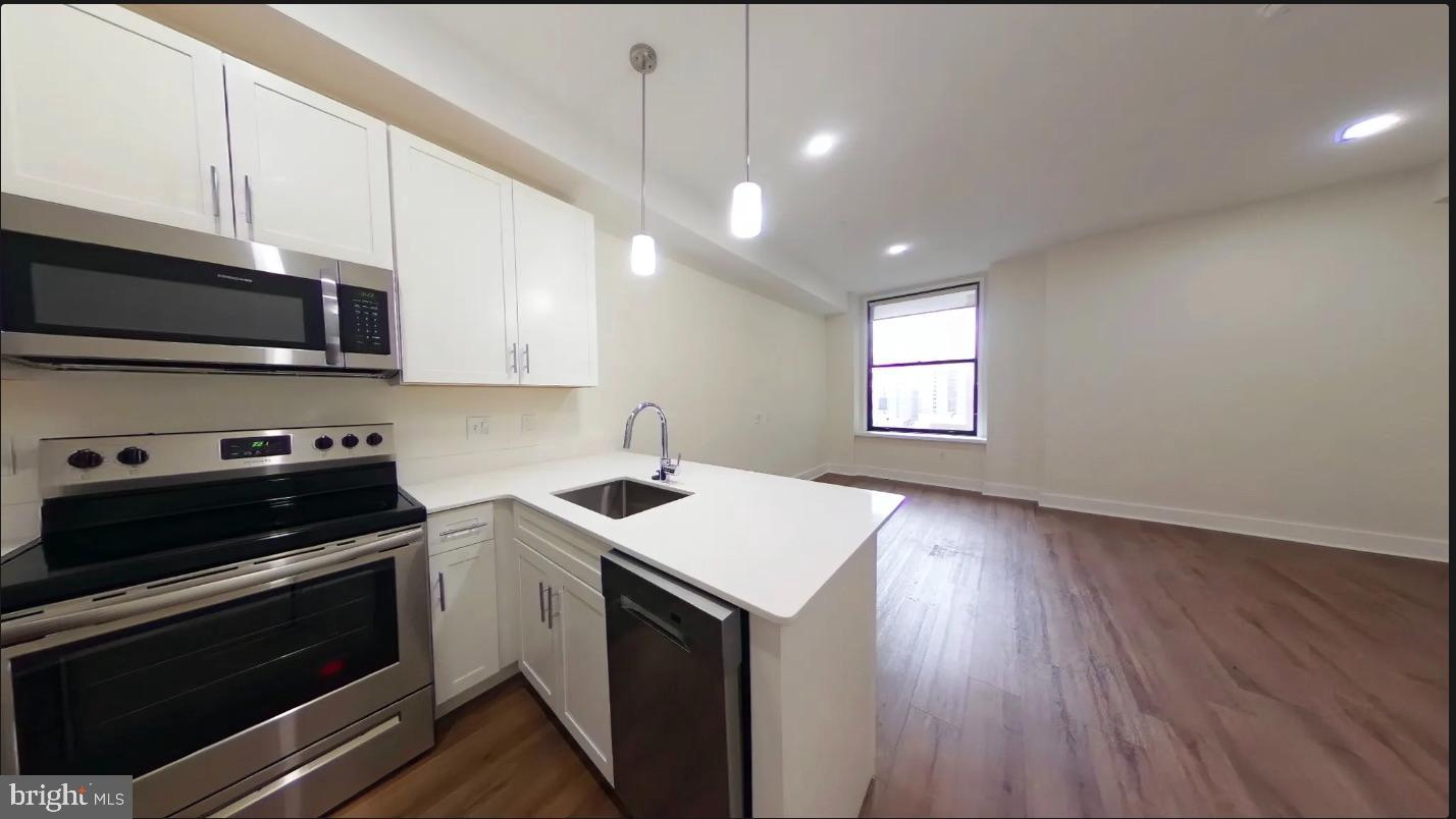 150 South Independence Mall West, Unit 802 Philadelphia, PA 19106 - Photo 5 of 9 a kitchen with a sink stove and microwave