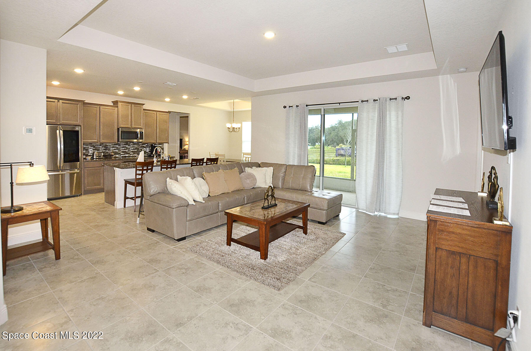 1923 Killian Drive Palm Bay, FL 32905 - Photo 14 of 44 a living room with furniture and a flat screen tv