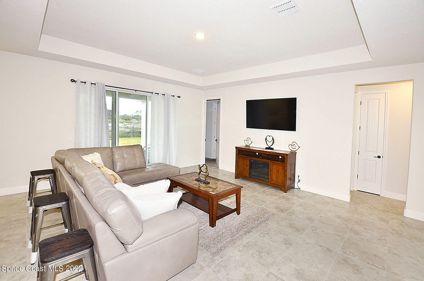 1923 Killian Drive Palm Bay, FL 32905 - Photo 15 of 44 a living room with furniture and a flat screen tv
