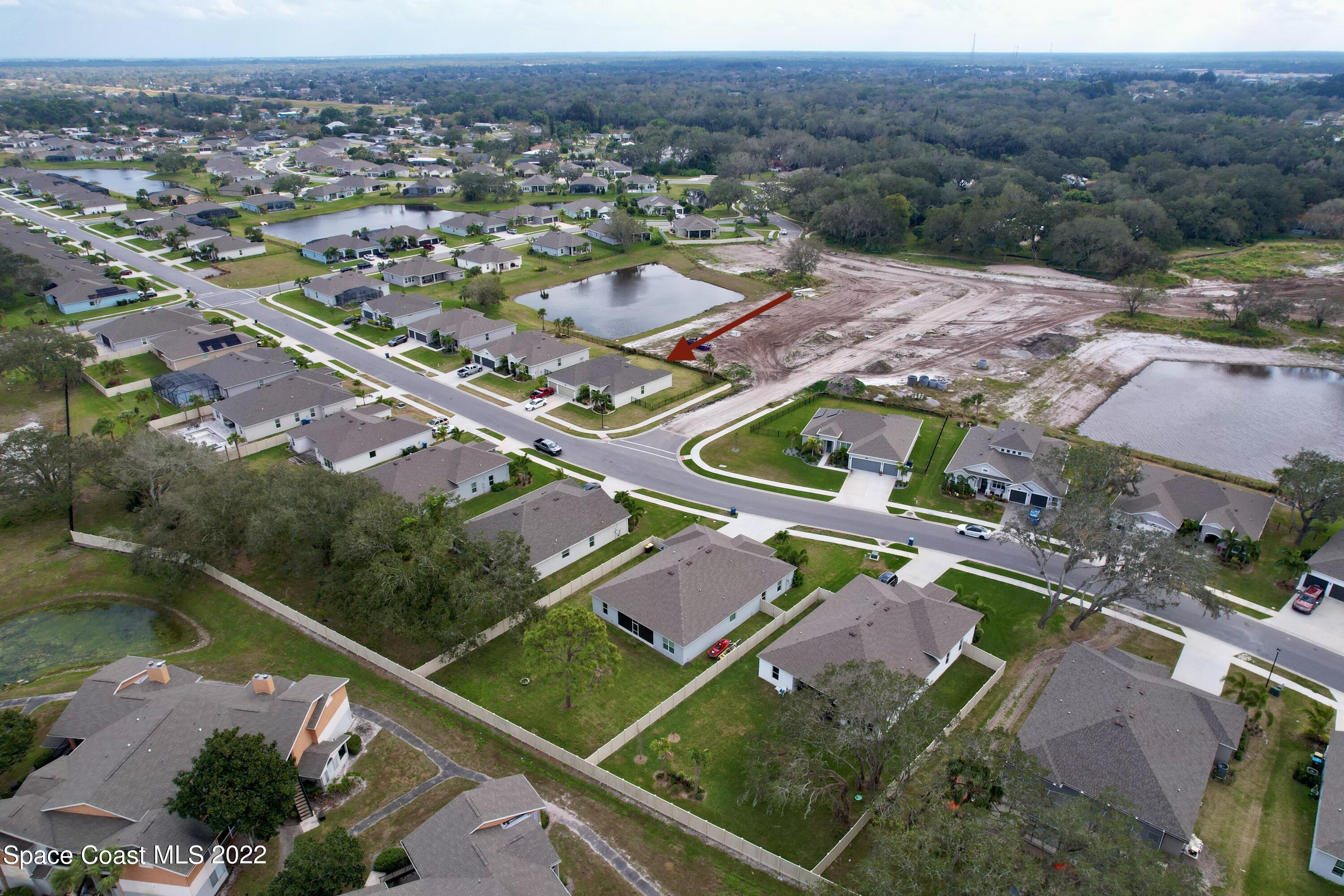 1923 Killian Drive Palm Bay, FL 32905 - Photo 2 of 44 an aerial view of residential houses with outdoor space and river