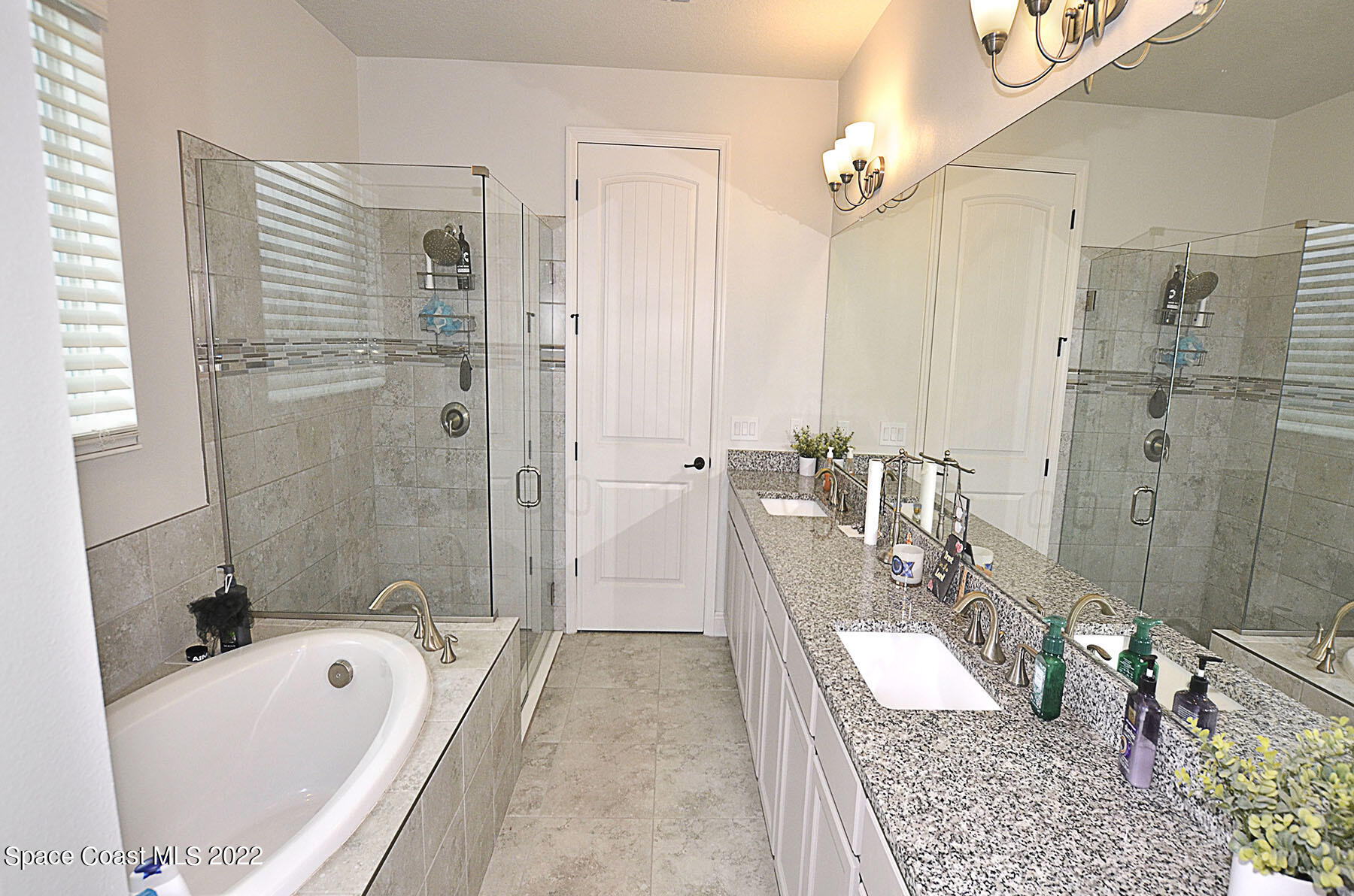 1923 Killian Drive Palm Bay, FL 32905 - Photo 25 of 44 a bathroom with a granite countertop tub sink a shower and a mirror