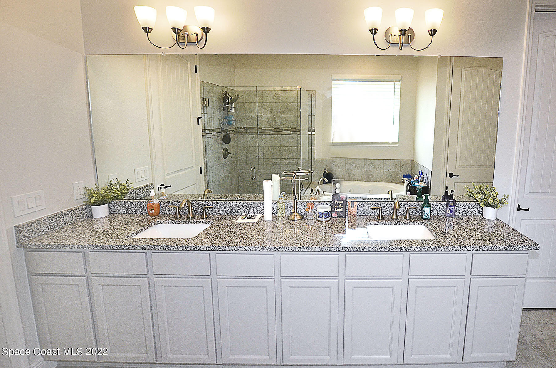 1923 Killian Drive Palm Bay, FL 32905 - Photo 26 of 44 a bathroom with a granite countertop sink a mirror and a vanity