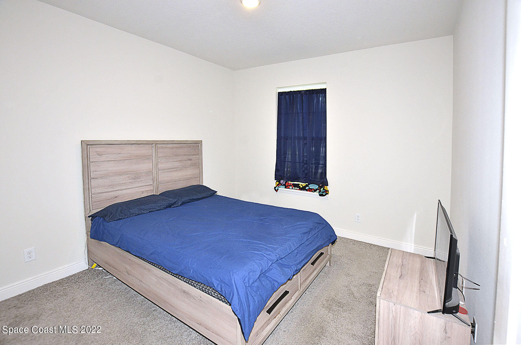 1923 Killian Drive Palm Bay, FL 32905 - Photo 30 of 44 a bedroom with a bed and a window