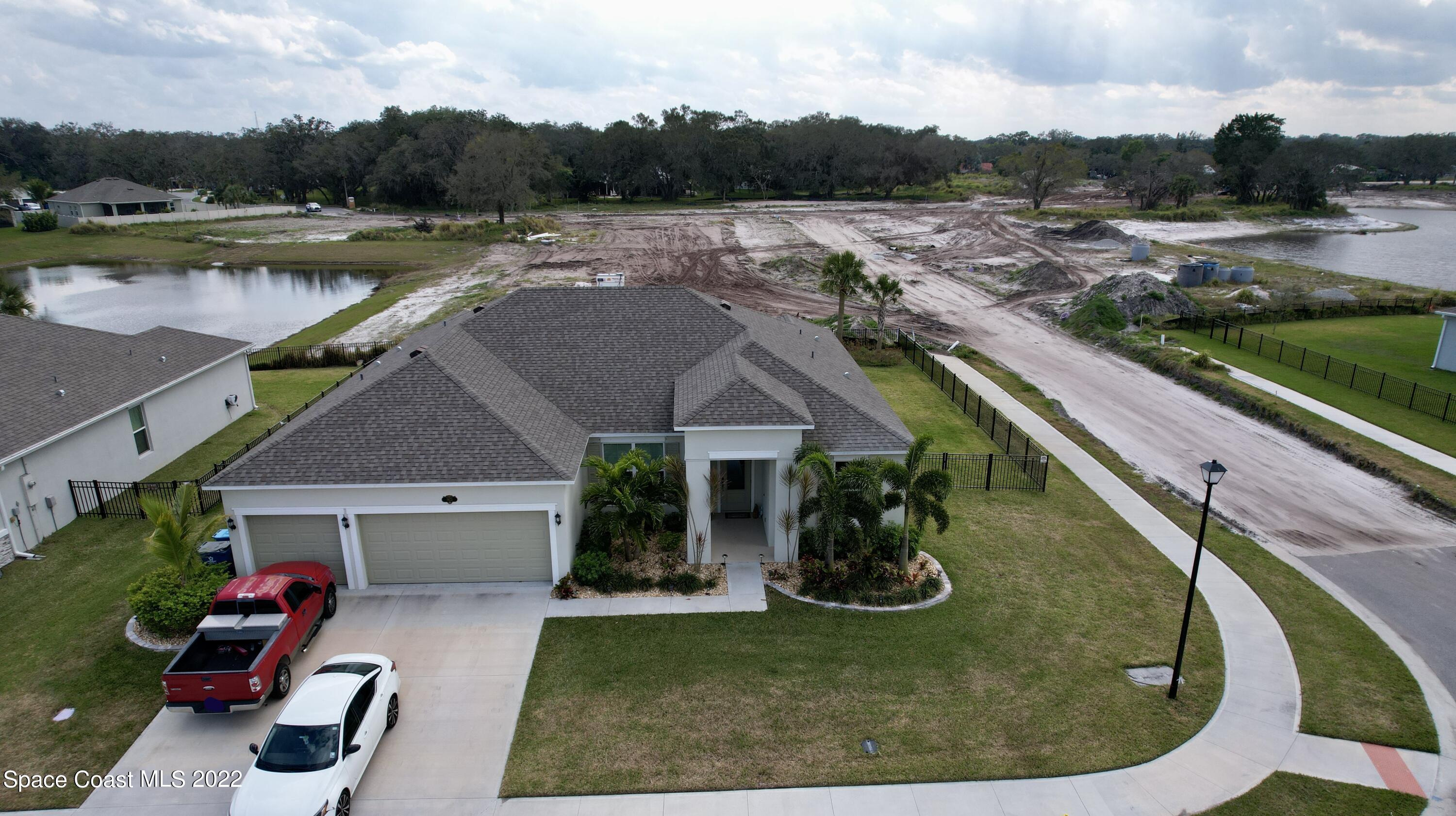 1923 Killian Drive Palm Bay, FL 32905 - Photo 6 of 44 an aerial view of a house with a yard and lake view