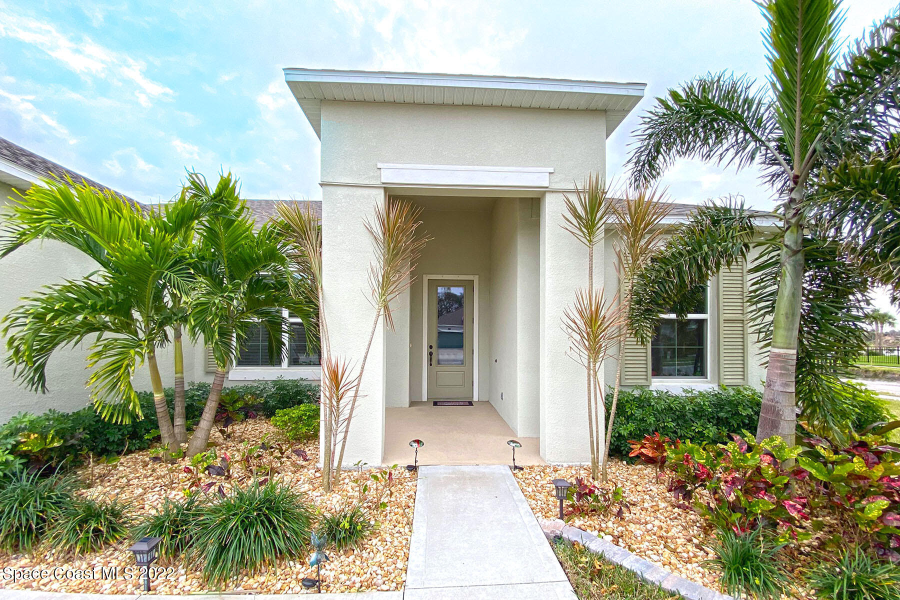 1923 Killian Drive Palm Bay, FL 32905 - Photo 9 of 44 a front view of a house with a garden