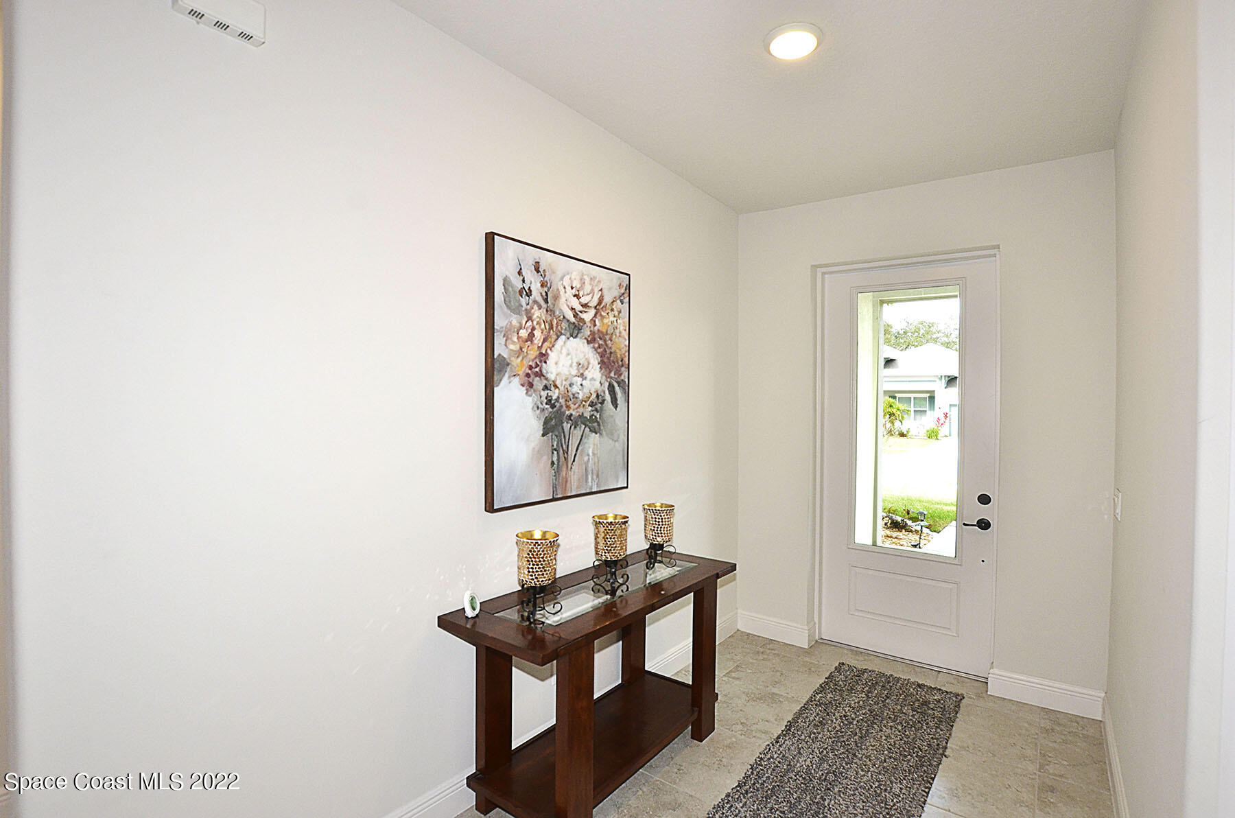 1923 Killian Drive Palm Bay, FL 32905 - Photo 10 of 44 a view of a hallway with wooden floor and a potted plant