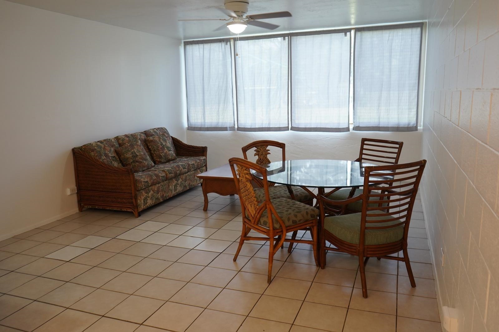 111 Kahului Beach Road, Unit C116 Kahului, HI 96732 - Photo 5 of 14 a view of a livingroom with furniture and a dining table with wooden floor